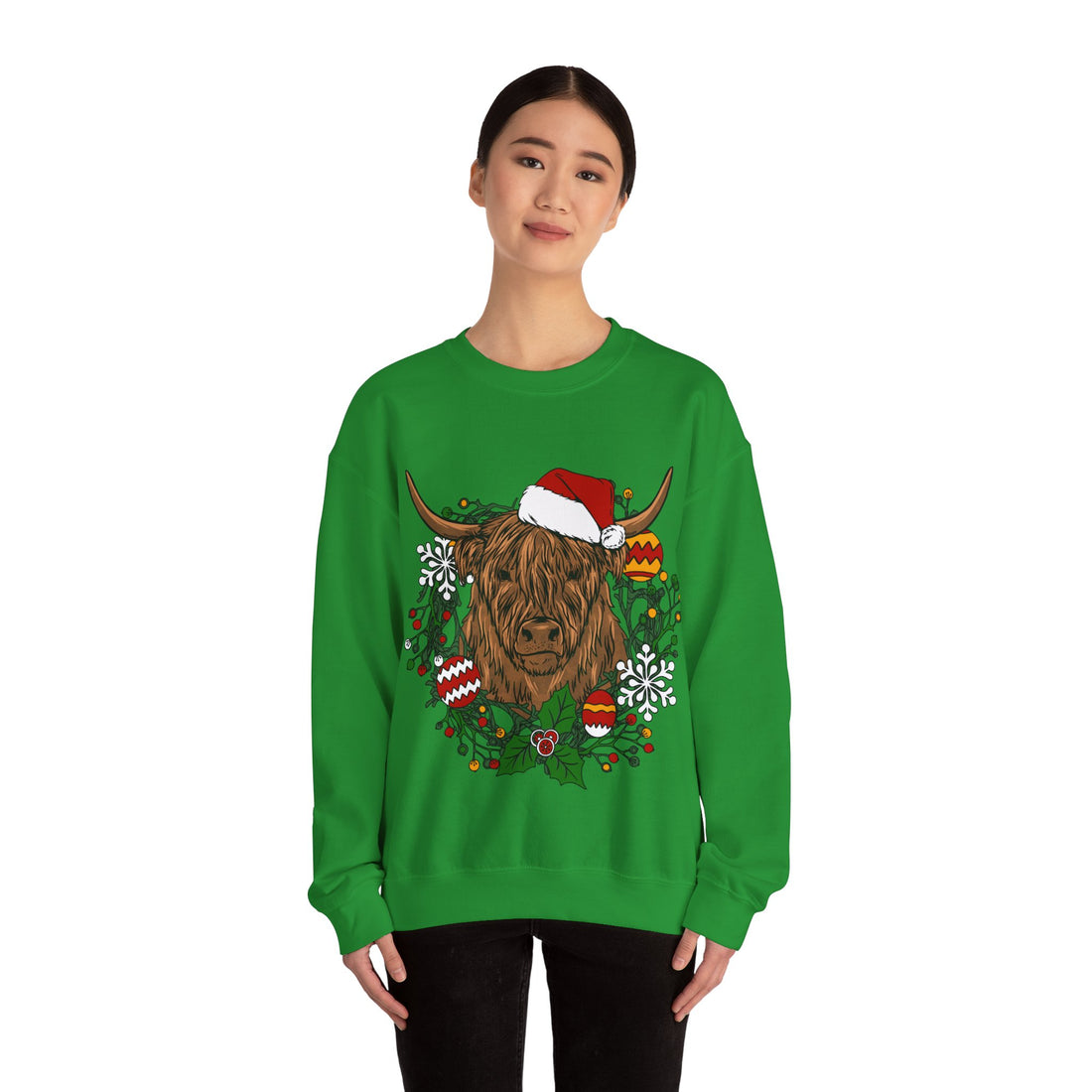 Shaggy Highland cow wearing a Santa hat framed by a holly and ornament Christmas wreath, detail