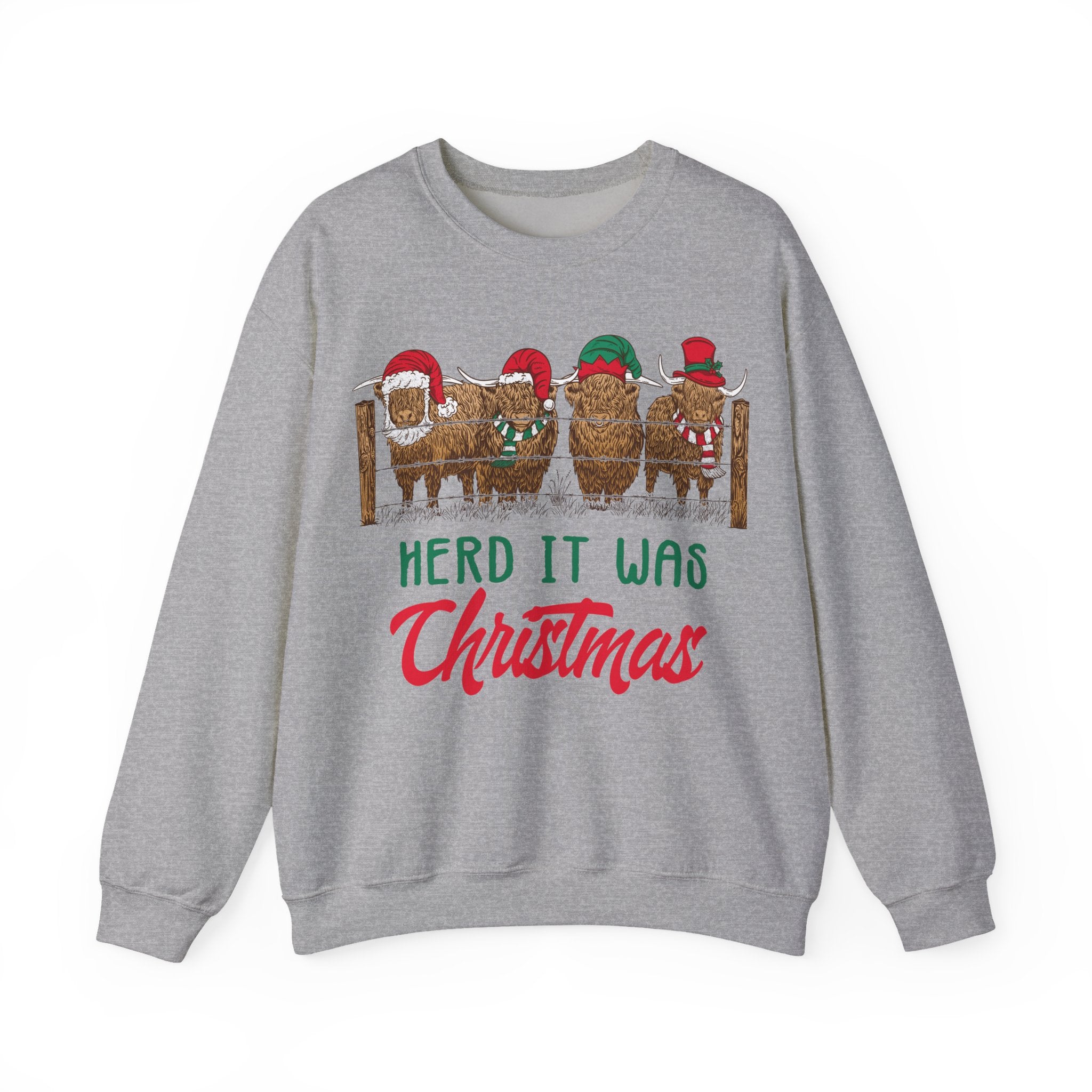 Four Highland cows lined up behind a wooden fence wearing Santa and elf hats with Herd It Was Christmas lettering in green and red, alternate view