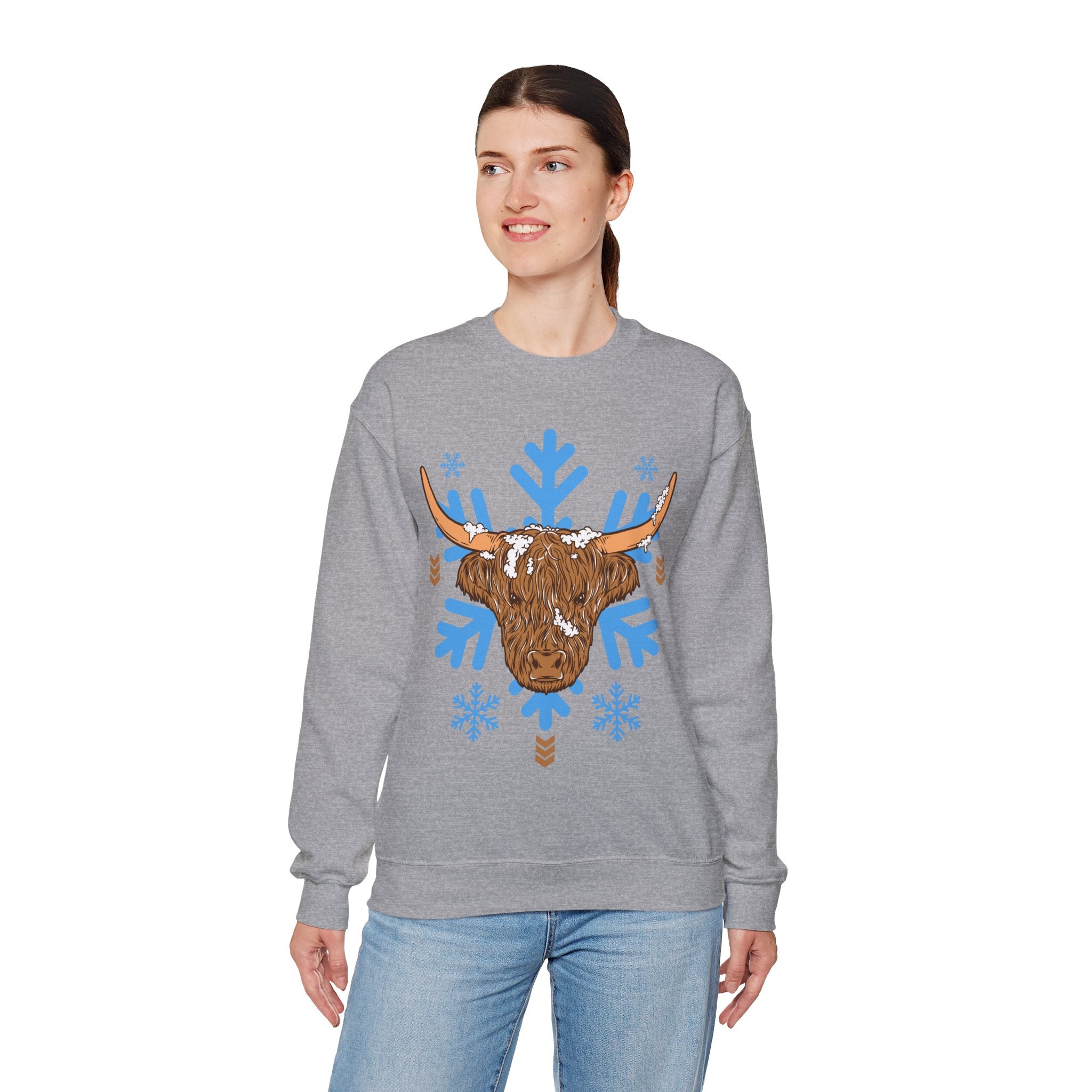 Shaggy brown Highland cow head centered over large light-blue snowflakes, alternate view