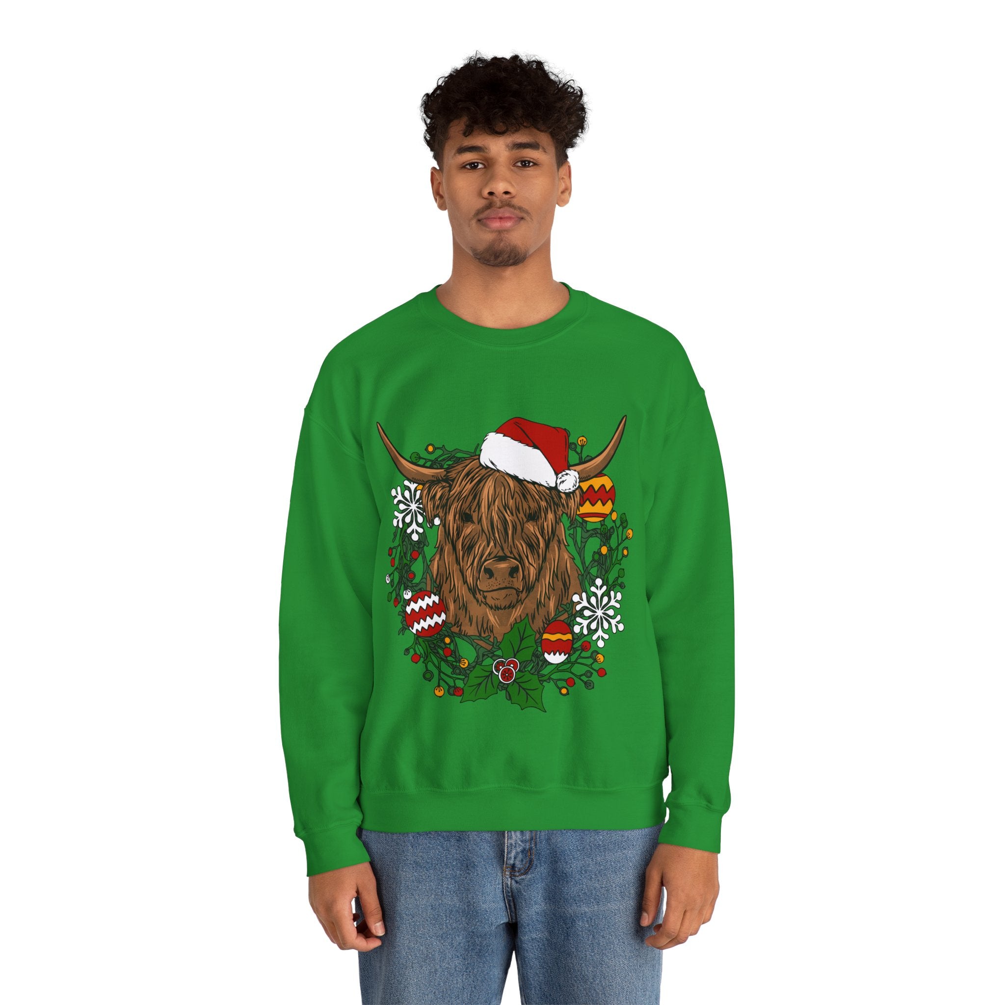 Shaggy Highland cow wearing a Santa hat framed by a holly and ornament Christmas wreath, alternate view