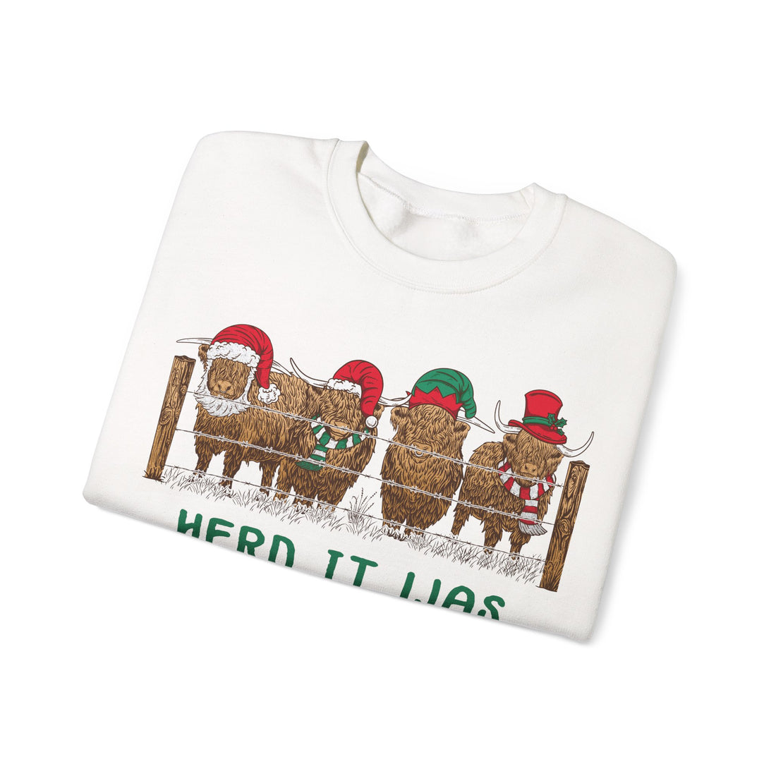 Four Highland cows lined up behind a wooden fence wearing Santa and elf hats with Herd It Was Christmas lettering in green and red, alternate view