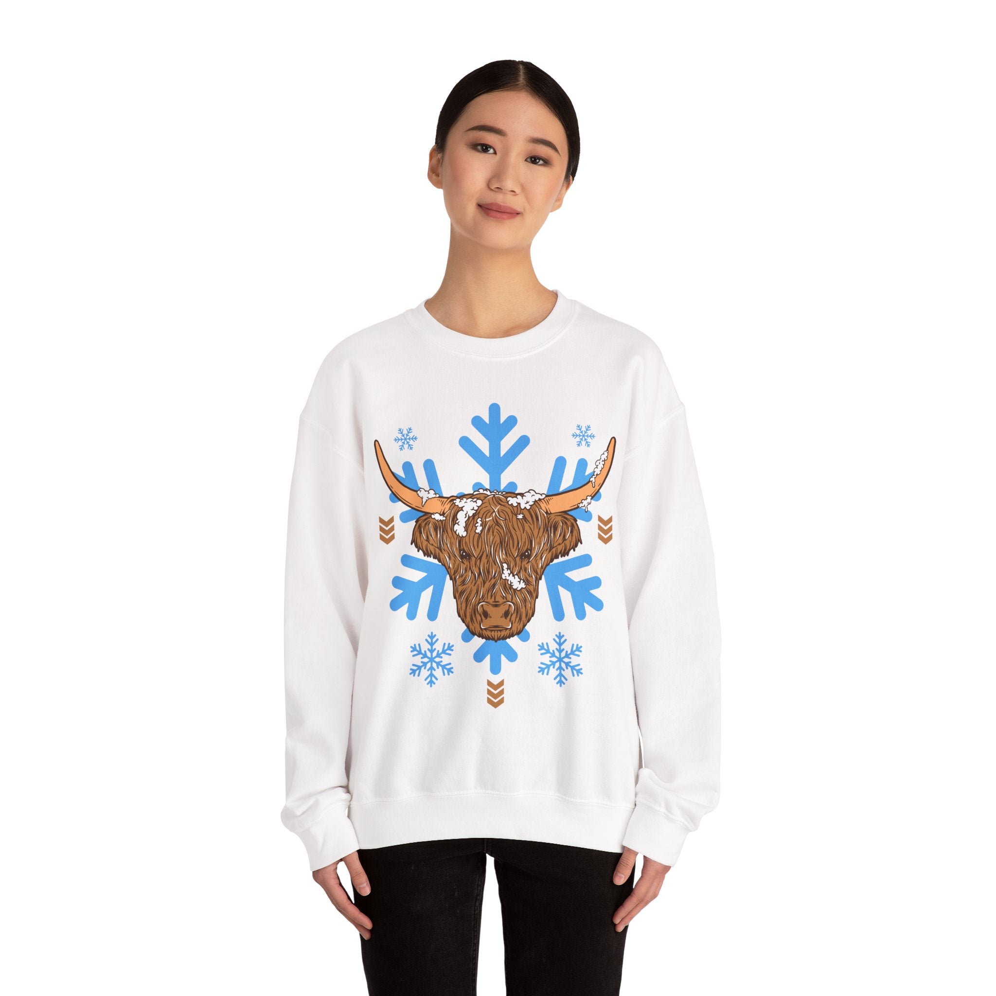 Shaggy brown Highland cow head centered over large light-blue snowflakes, detail