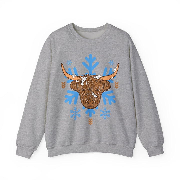 Shaggy brown Highland cow head centered over large light-blue snowflakes, alternate view