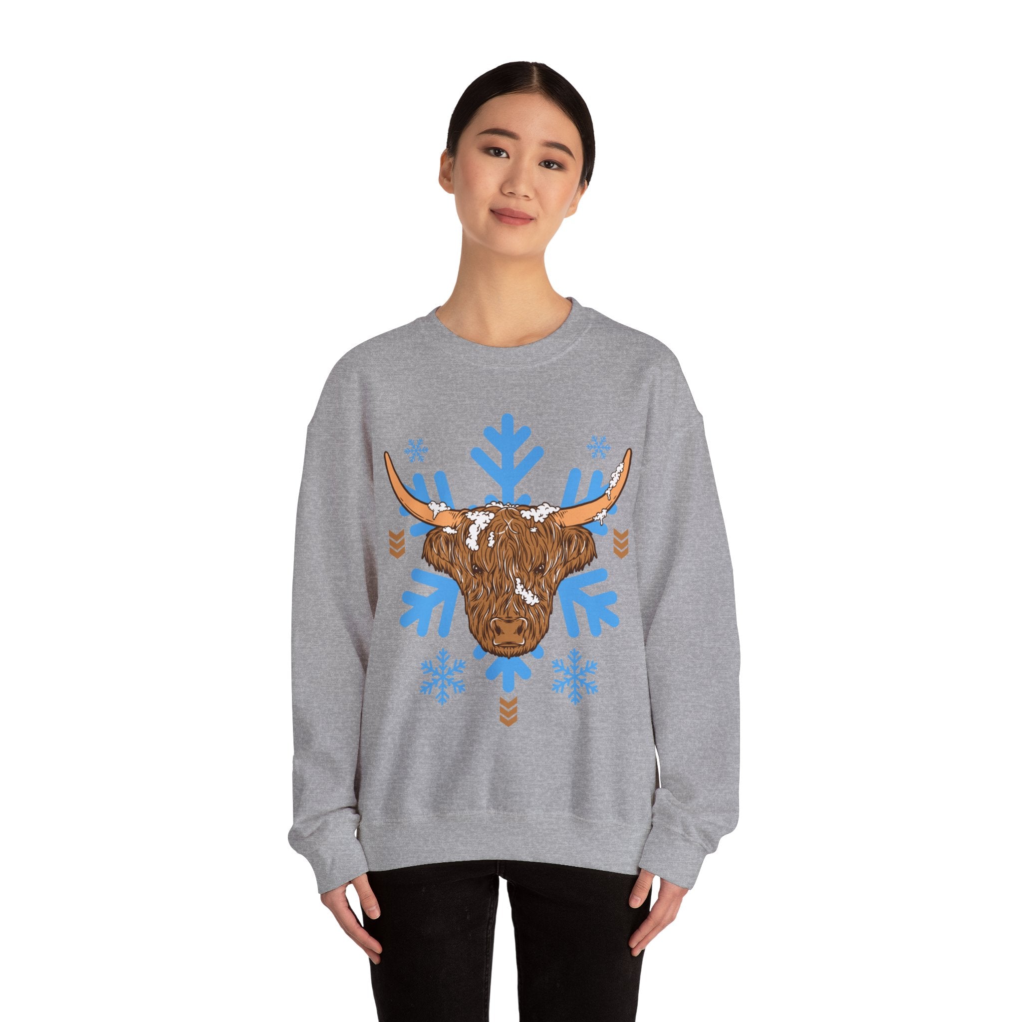 Shaggy brown Highland cow head centered over large light-blue snowflakes, color option