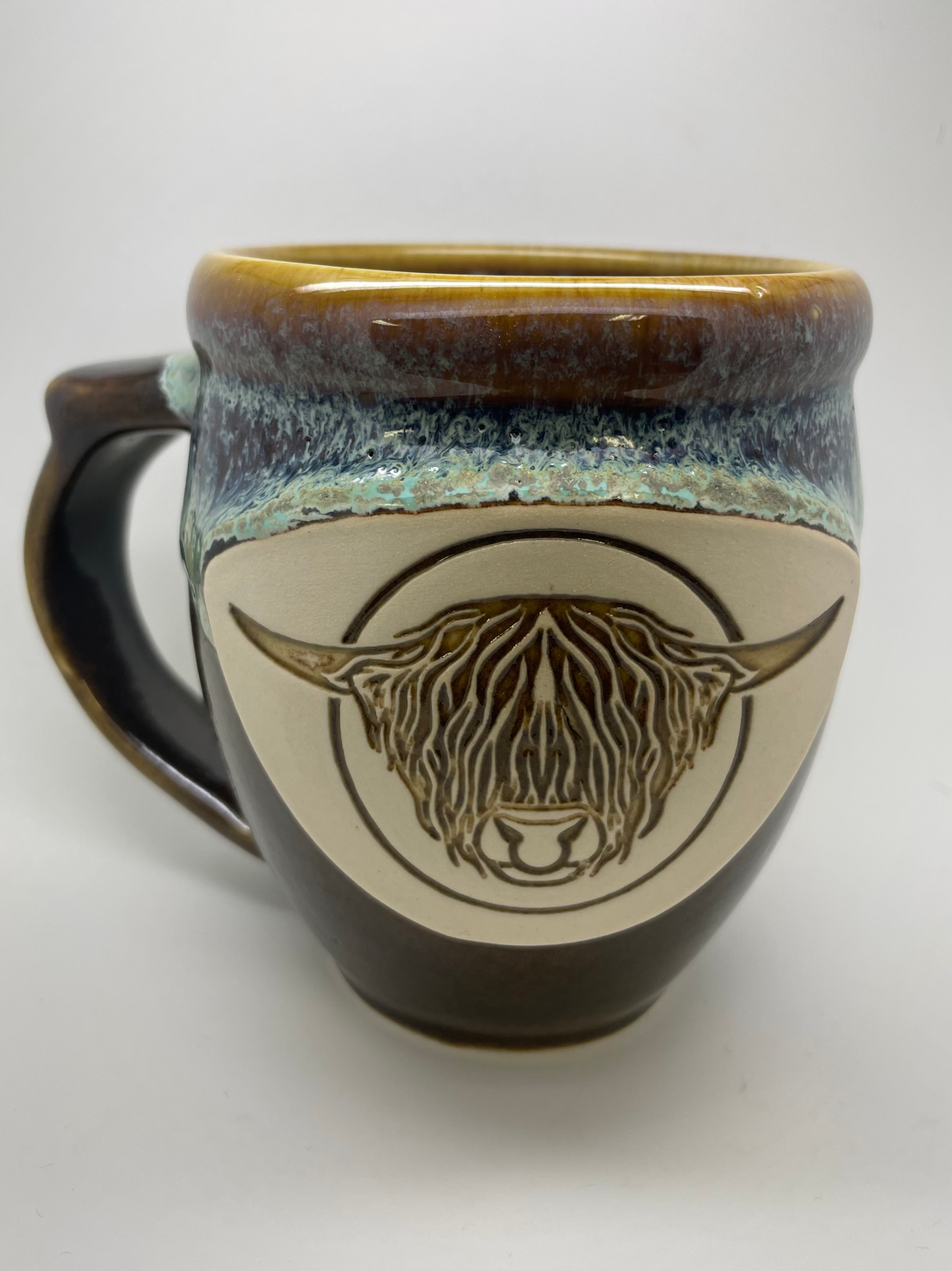 Handmade pottery mug with Highland bull head, detail